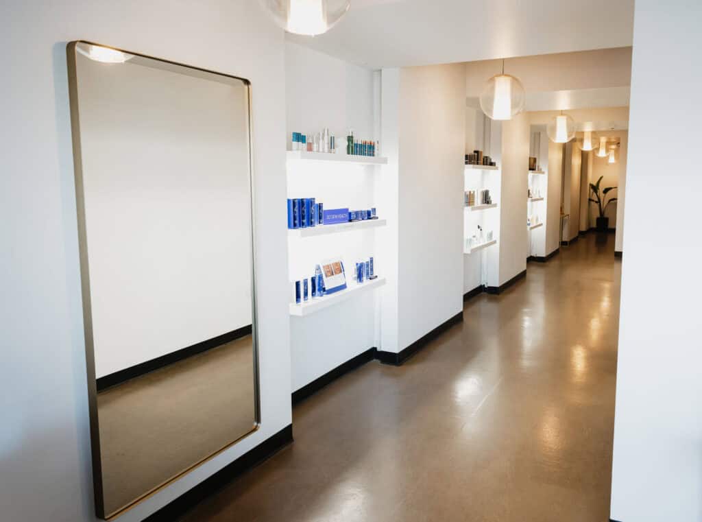 Modern beauty store hallway with products on shelves.