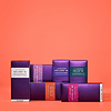 Assorted Juvederm filler product boxes on coral background