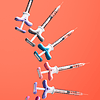Juvederm dermal filler syringes on coral background