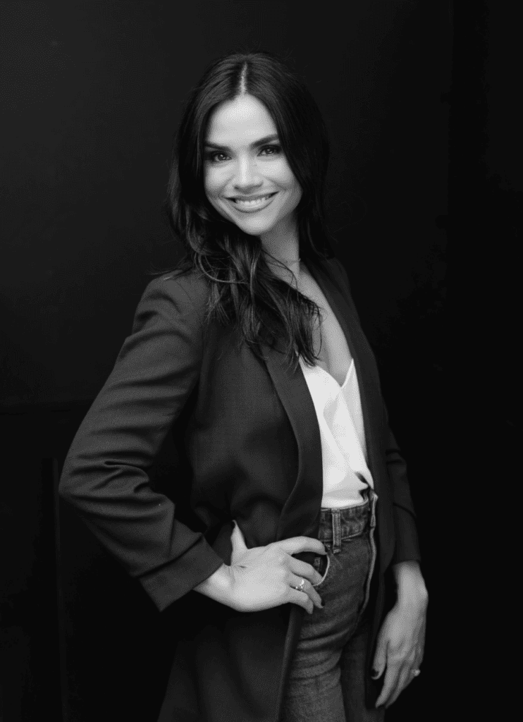 Smiling woman in blazer and jeans portrait