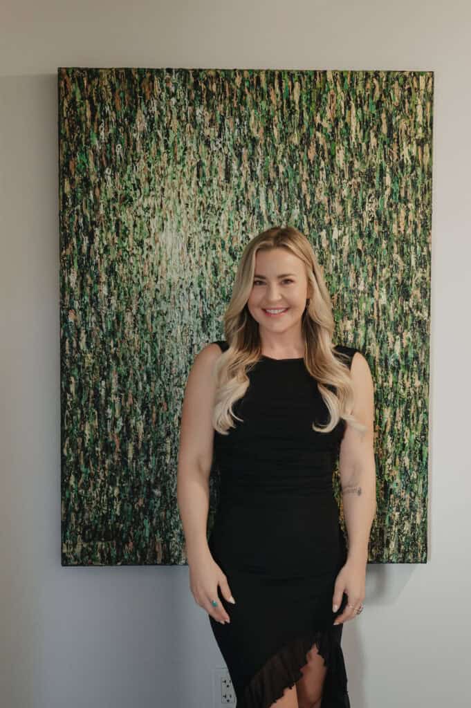 Person standing in front of abstract painting