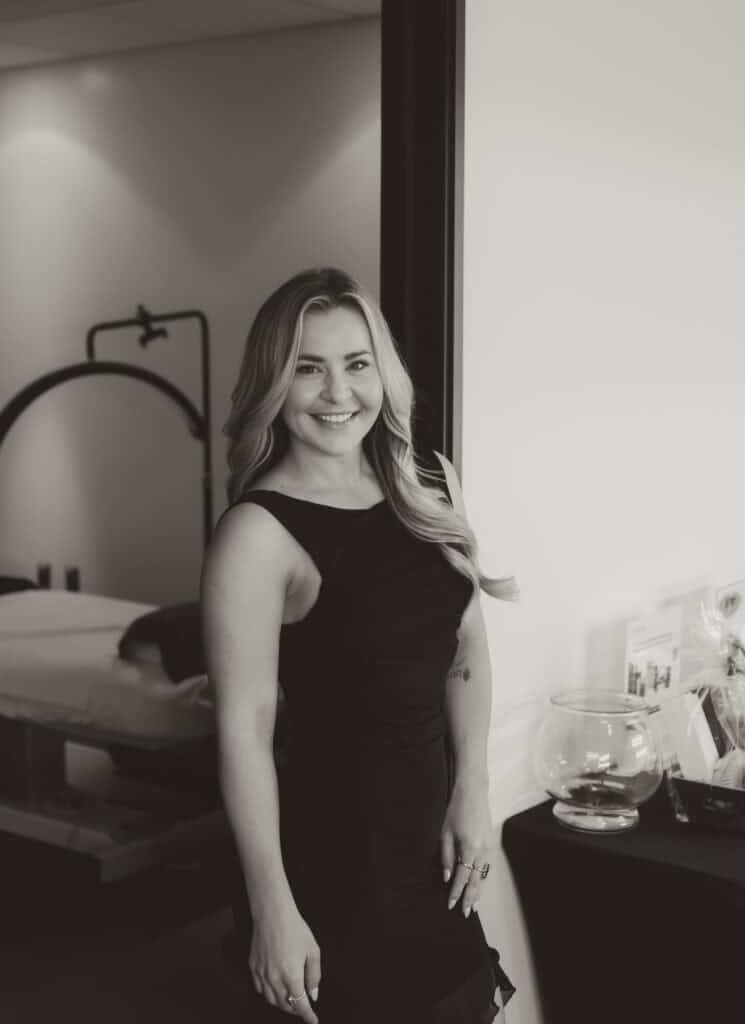 Woman smiling in a professional office setting.
