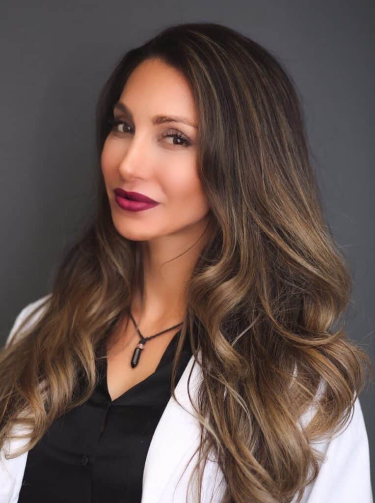 Woman with long hair in professional attire.